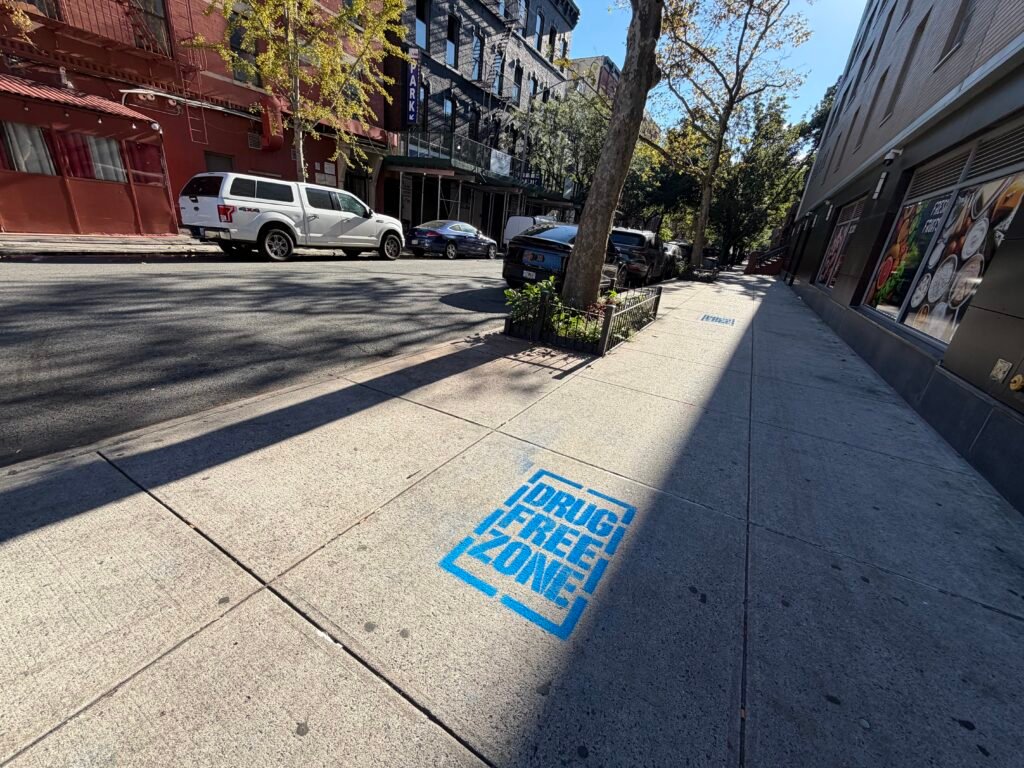 Blue Drug Free Zone sidewalk stencil installed in Harlem, NYC
