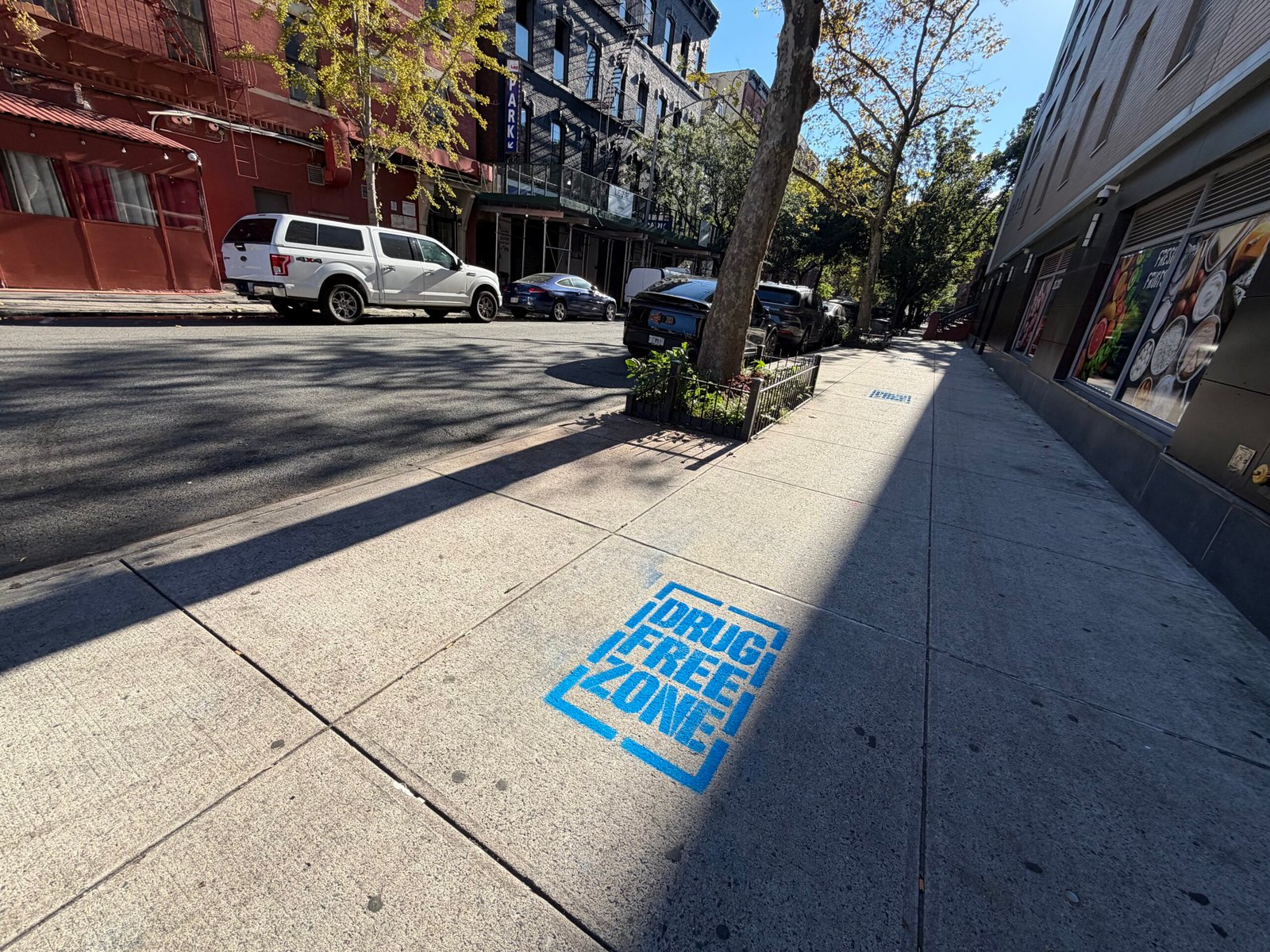 Blue Drug Free Zone sidewalk stencil in Harlem, New York City