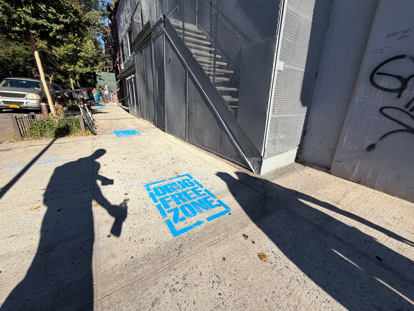 Blue sidewalk stencil installation for a Harlem community awareness project