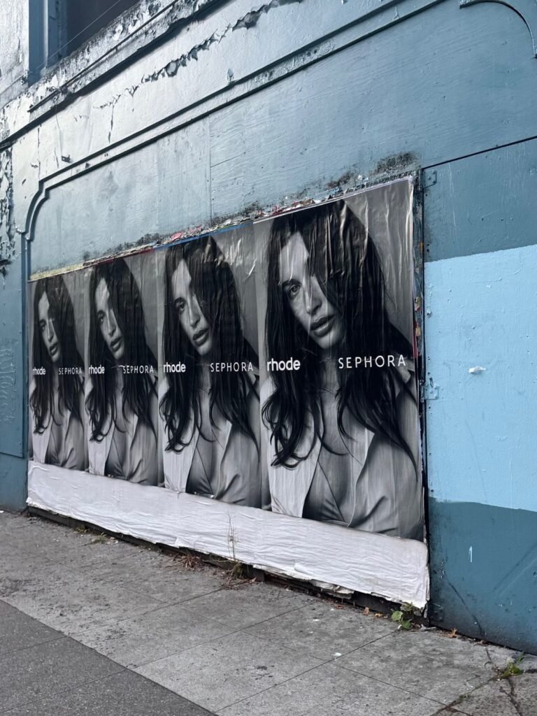 Repeated black-and-white Rhode and Sephora street posters